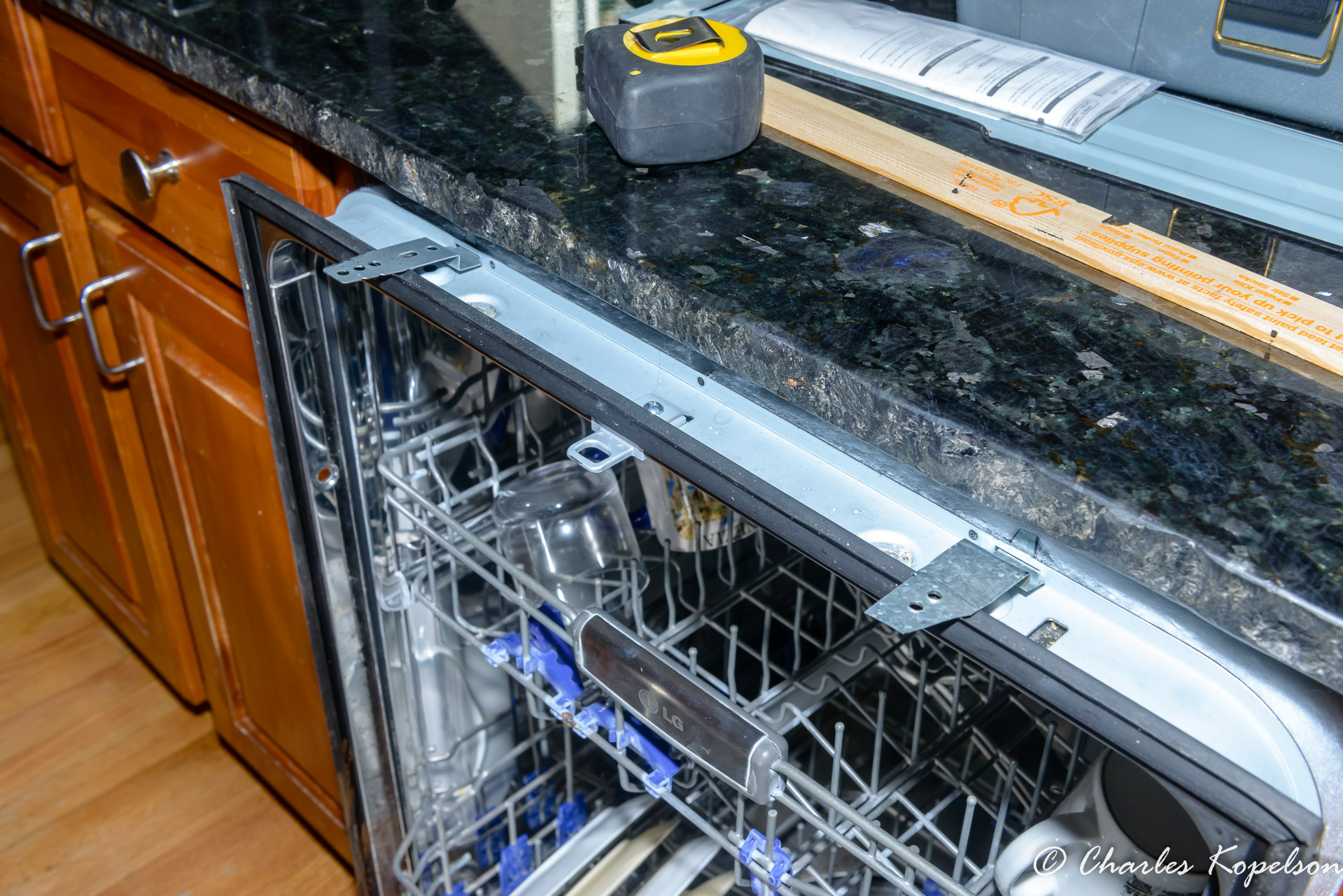 The 2 brackets in place before the dishwasher is pushed back.