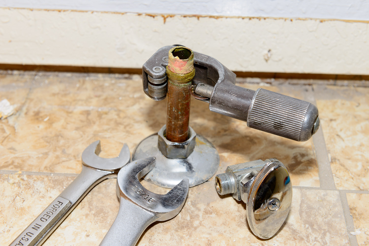 I use a tubing cutter to remove the top secton of pipe where the old compression fitting is