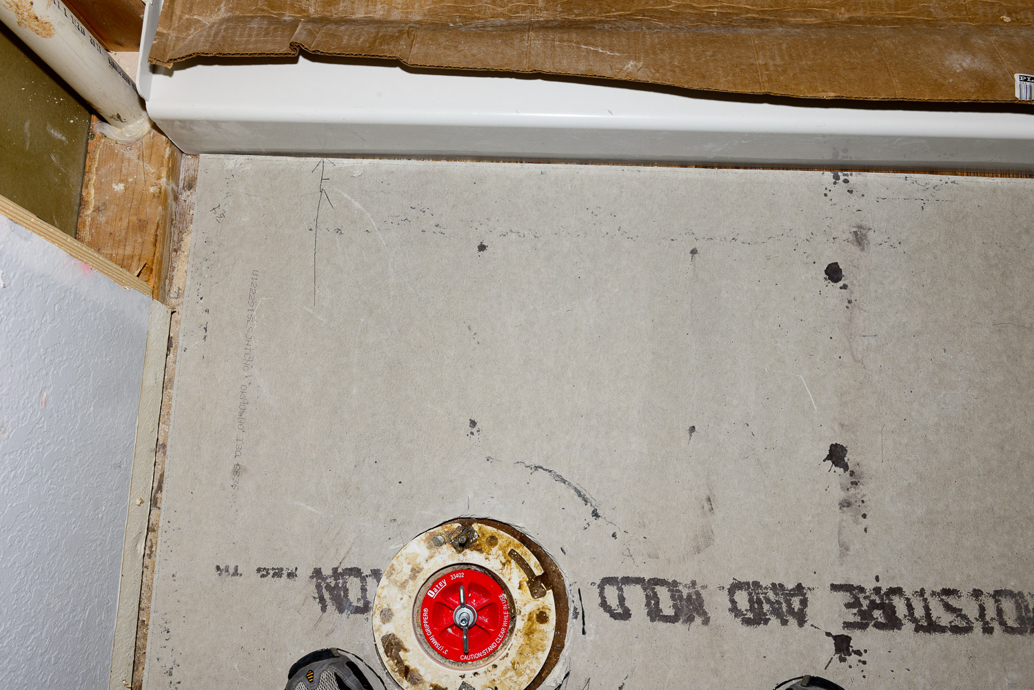 You want to make sure you leave around 1/8" `space for caulk between the underlayment board and the shower base.