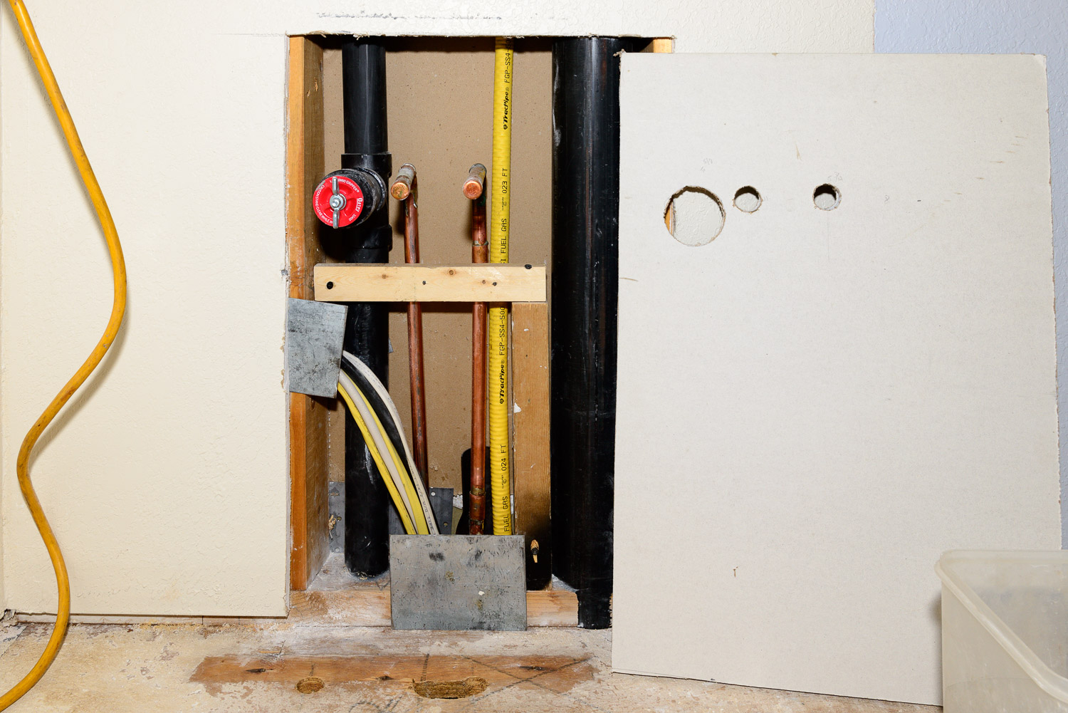 Places where utilities go through a stud should have a steel plate inserted. The reasoning is that studs are hammered and drilled into on a regular basis to hang things on the walls and to fasten baseboard trim with a nail gun at the floor