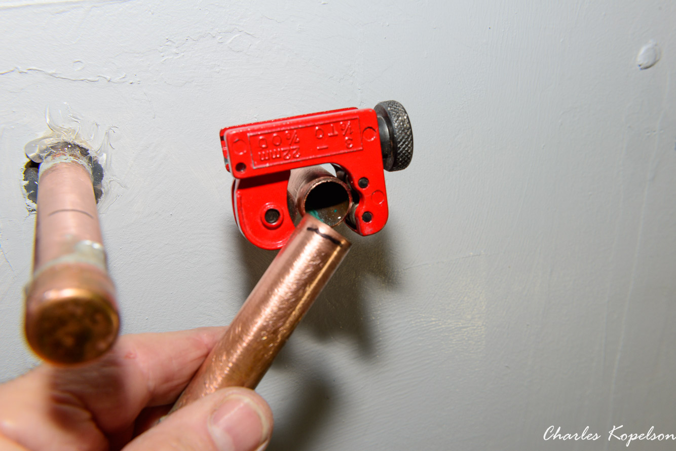 Make sure the water in the house is shut off. Use a small tubing cutter to cut the ends off the water supply lines.