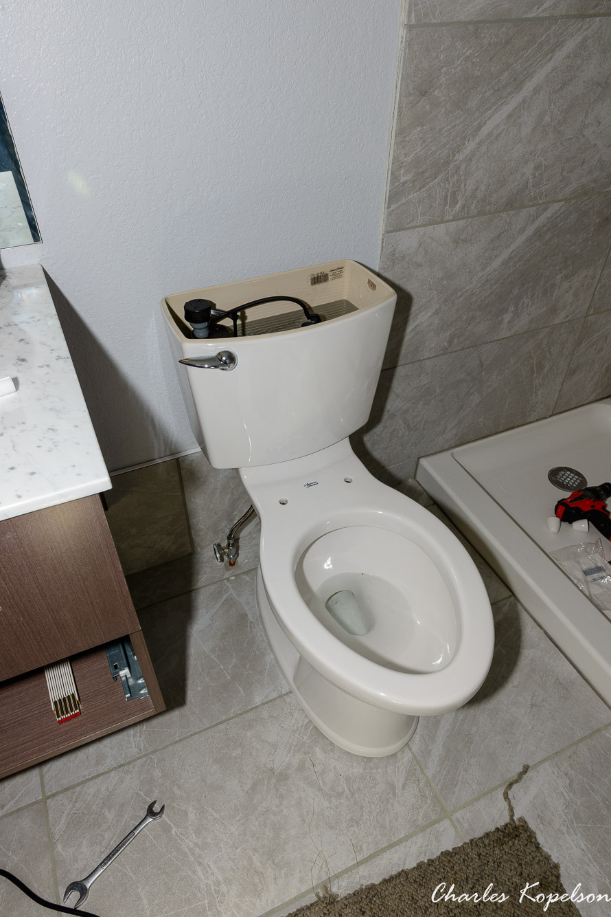 Turn the water on and the tank and bowl will fill to the line in the tank. If it doesn't adjust the level with the screw on the float. If the toilet rocks on the floor because the tile isn't perfectly flat you can caulk around the bottom edge of the bowl. Your new toilet is now operational.