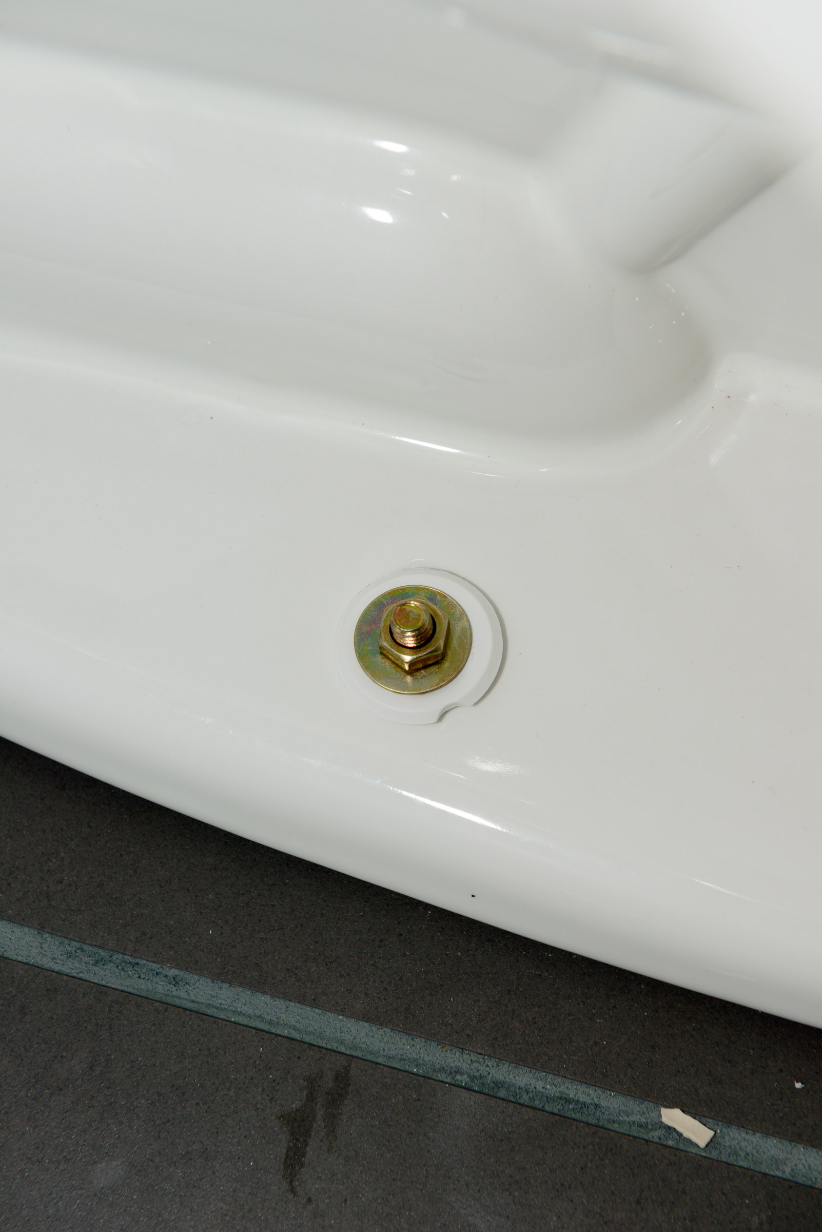 Toilet mounting bolts. The white washer is the clip that the bolt cover  snaps into.
